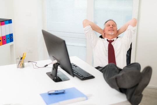mature man relaxing in his office