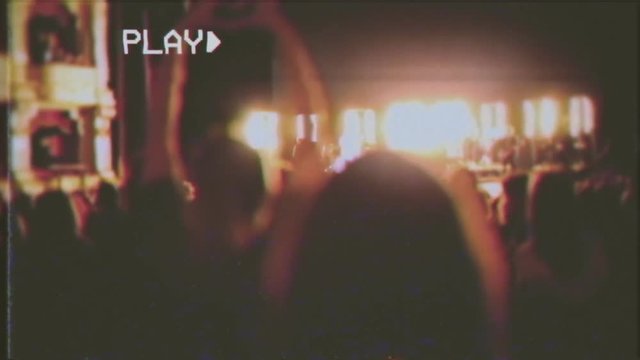 VHS Retro Fake Shot: The Ending Of A Pop-rock Concert, With A Cheeering Crowd; Shot From Behind.
