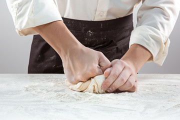 Hands kneading a dough