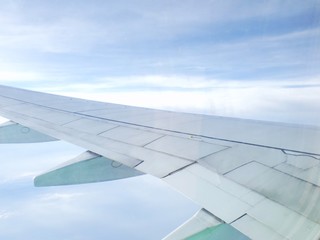 Fototapeta premium clouds and sky as seen through window of an aircraft