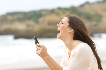 Girl holding a smart phone crying desperately