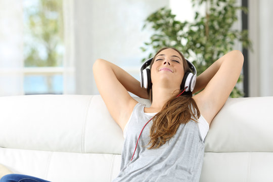 Woman relaxing listening music at home