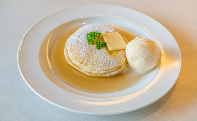 Pancake  with ice cream on table .