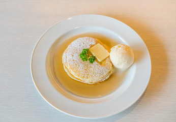 Pancake  with ice cream on table .