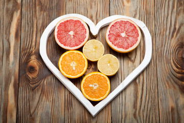Citrus fruit in a heart on  wooden background