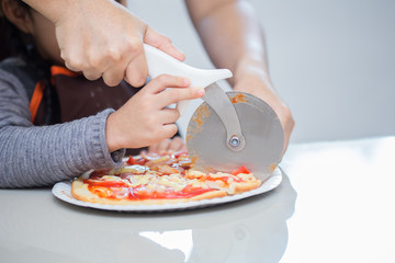 Asian mother and daughter enjoy making pizza