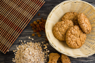 Oatmeal cookies and ingredients on a wooden table in rustic style