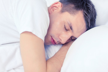 handsome man sleeping in bed