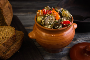 Baked vegetables with sesame seeds on a wooden background in rustic style