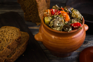 Baked vegetables with sesame seeds on a wooden background in rustic style