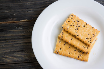 Crackers with sesame seeds on a wooden table in rustic style