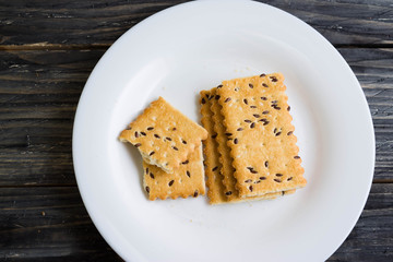 Crackers with sesame seeds on a wooden table in rustic style