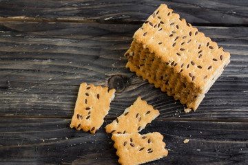 Crackers with sesame seeds on a wooden table in rustic style