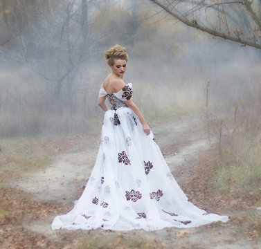  lady in vintage dress in the forest in the fog.