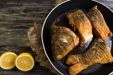 Fried carp on a frying pan in a rustic style