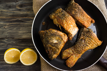 Fried carp on a frying pan in a rustic style