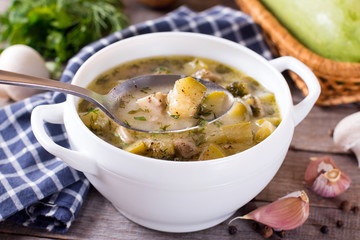 Fresh vegetable soup on wooden table