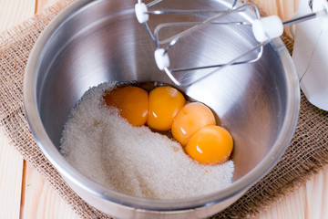 Egg yolks and sugar in a metal bowl