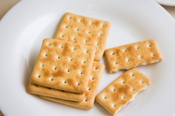 Crackers on a white plate and coffee. Tasty and nutritious breakfast.