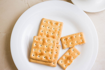 Crackers on a white plate and coffee. Tasty and nutritious breakfast.