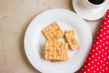 Crackers on a white plate and coffee. Tasty and nutritious breakfast.