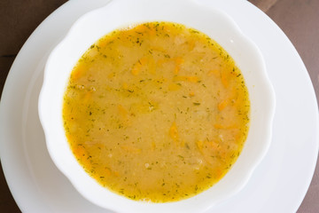 Pea soup in a white bowl on a marble table