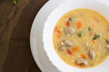 Flour soup with chicken giblets in a white bowl