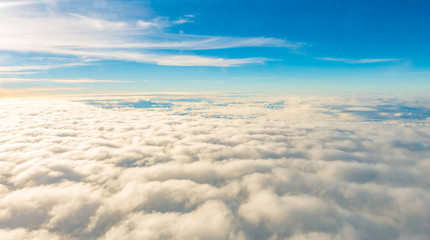 Fototapeta na wymiar Sunrise above clouds from airplane window .