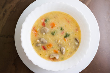 Flour soup with chicken giblets in a white bowl