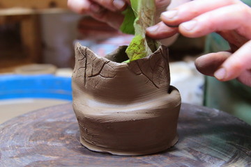 Clay pot on a pottery wheel