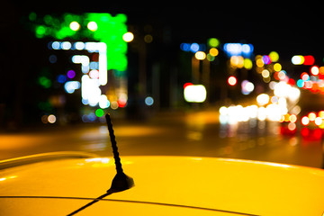 Roof of a yellow taxi cab in city at night