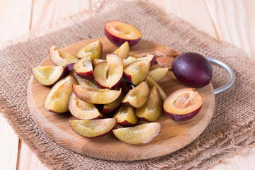 Fresh plums on a wooden board