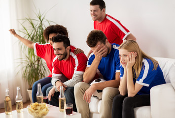 friends or football fans watching soccer at home