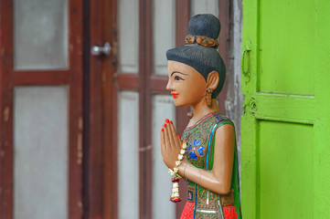 Carved wooden puppets say hello form thailand