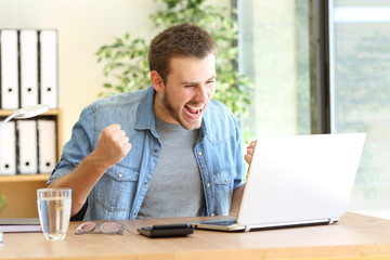 Excited entrepreneur with laptop on line