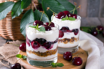 Dessert with a cherry and oat flakes in a glass