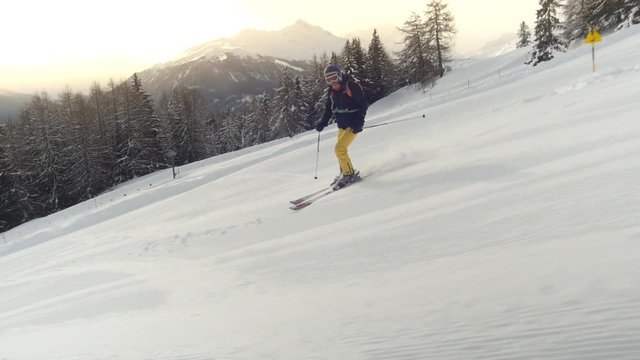 camera fluently tracking along with skier going downhill