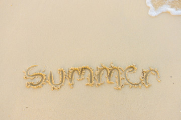 Summer text with white sandy beach and sea .