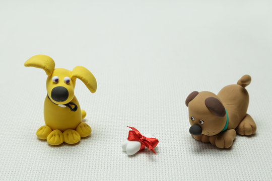 Two dogs and a bone tied up by a band