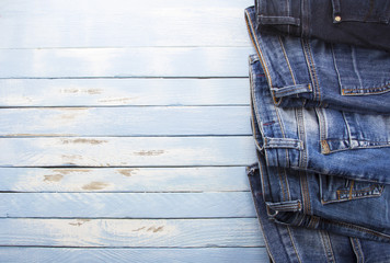 blue jeans fashionable clothes shirt pants Blue rusty vintage wood background
