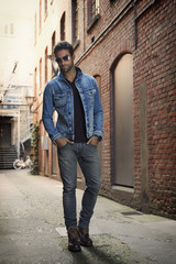 Fototapeta na wymiar Man wearing denim jacket and jeans in street