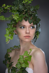Fototapeta premium young woman in a wreath of leaves