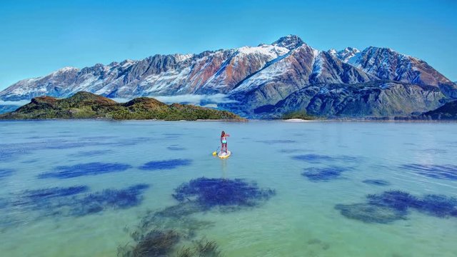 Young attractive woman in the sea on the Stand Up Paddle Board. SUP. Healthy lifestyle.