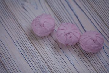 pink marshmallow - zephyr on a light wooden table