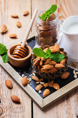 Almond milk with ingredients and honey for healthy breakfast