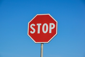 Red Stop Sign with Blue Sky Background