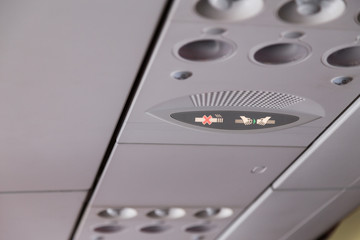 Plane interior No Smoking and Buckle Seat-Belt signage
