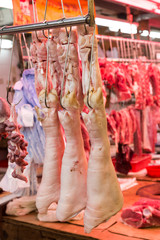 Fresh pork legs, intestine and meat at market stall