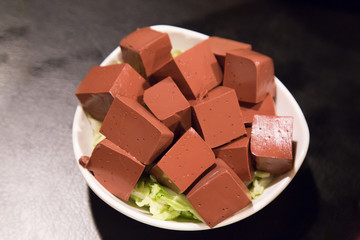 Plate of hardened pig blood in cubes, delicacy among Chinese