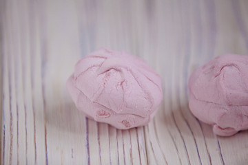 pink marshmallow - zephyr on a light wooden table